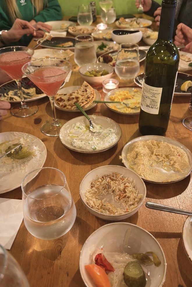Mezze dishes, dips and drinks across a shared table