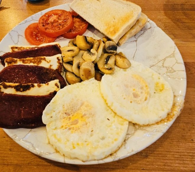 A full English breakfast on a wooden table